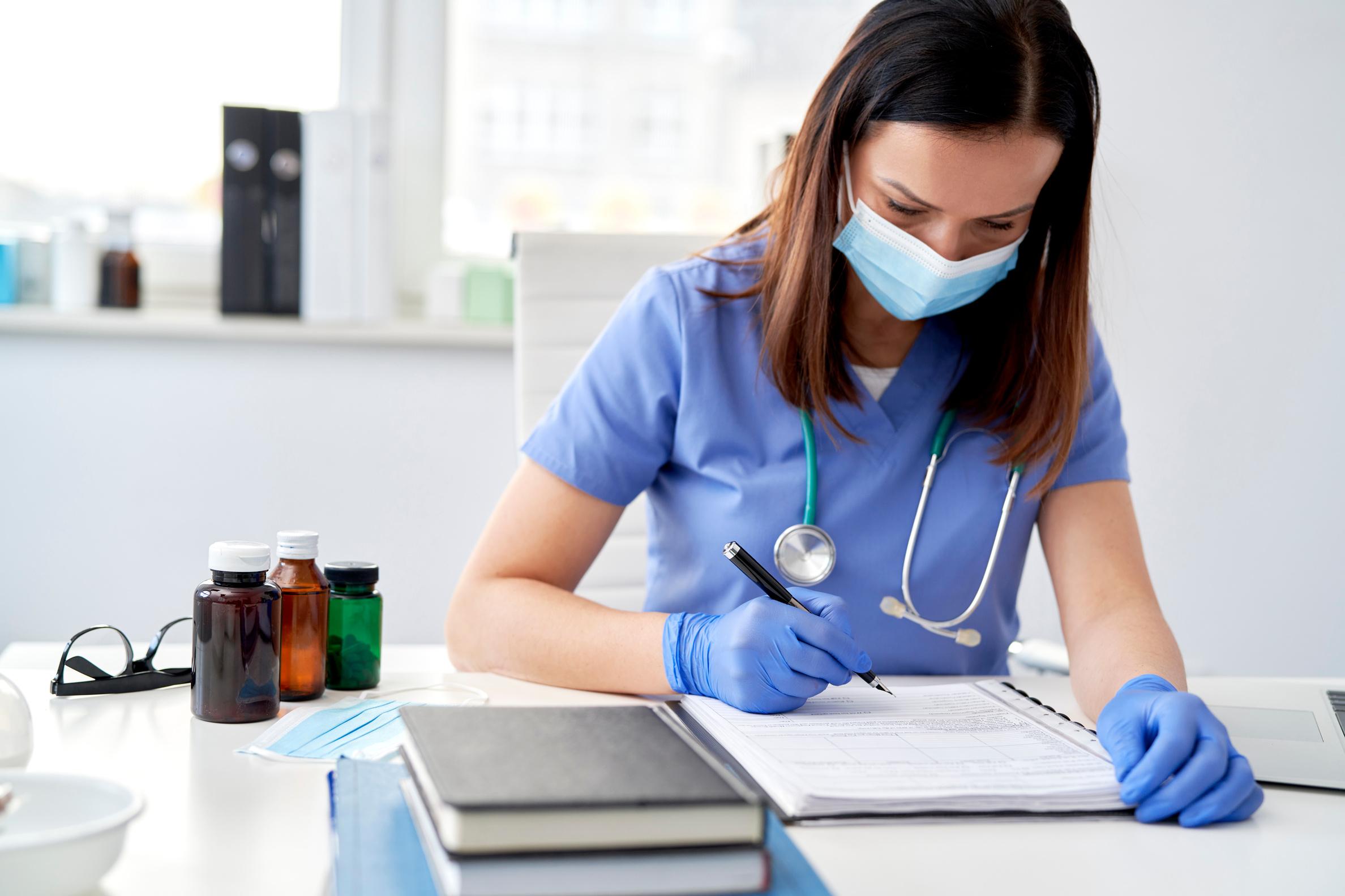 doctor typing on keyboard taking patient notes